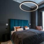 Stylish modern bedroom in Prague featuring a contemporary ring light and cozy bedding.